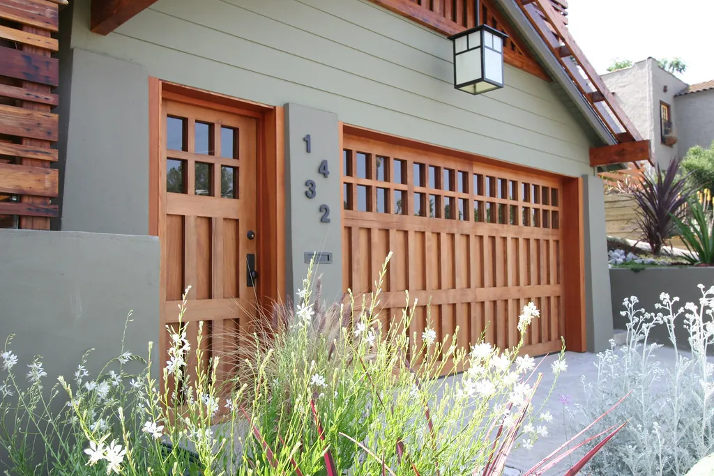 Craftsman-style wood garage door with glass panes